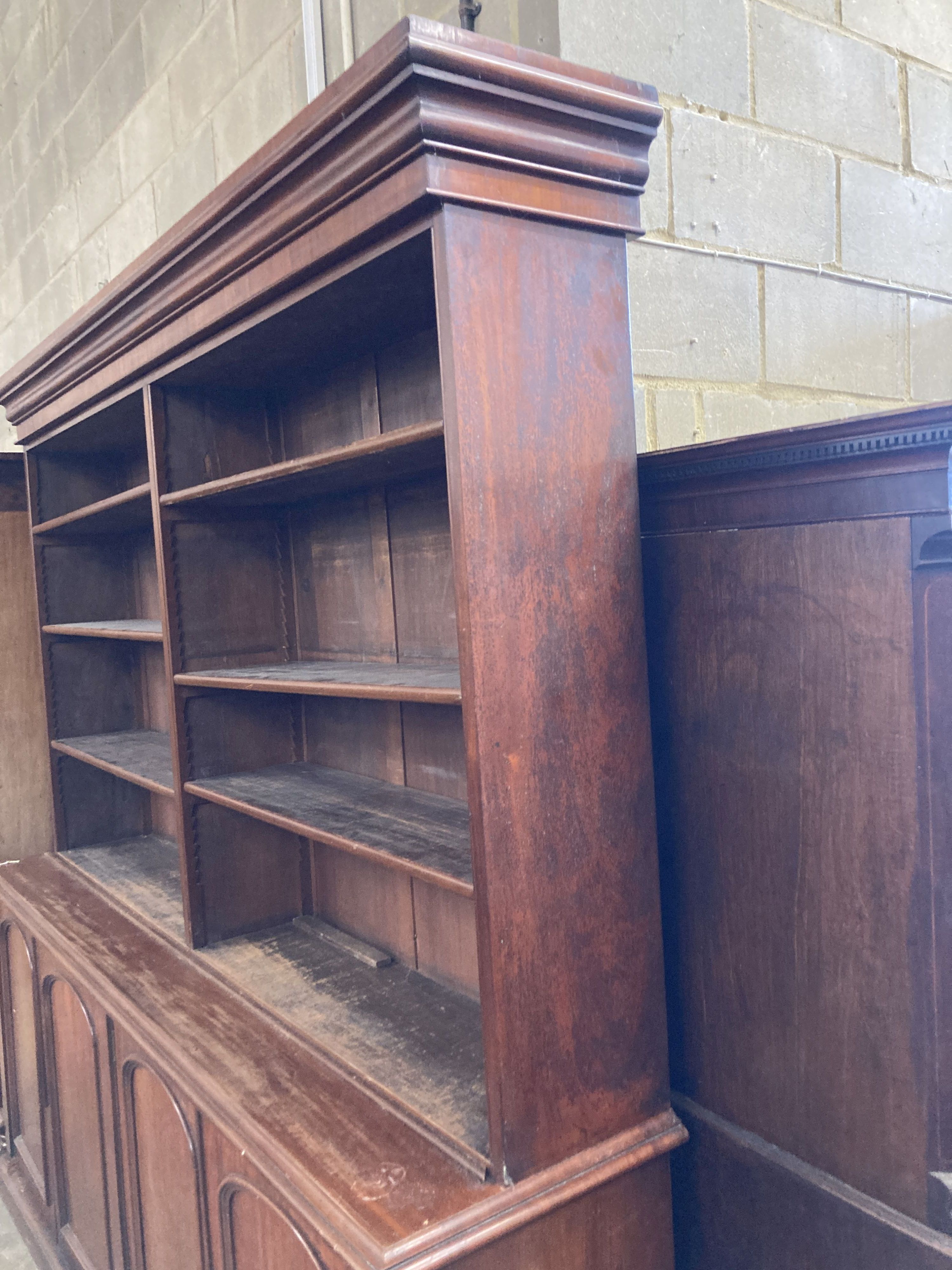 A Victorian mahogany library bookcase, the open shelves over an enclosed four door base, length 230cm, depth 50cm, height 238cm